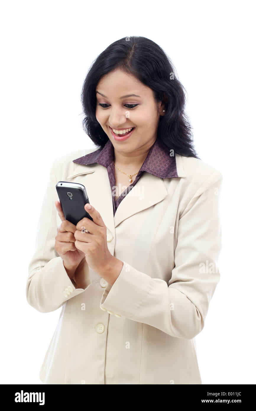 Excited young Indian business woman text messaging Stock Photo - Alamy