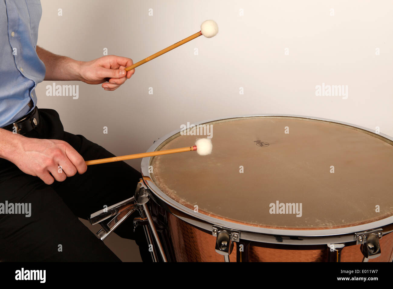 Timpani player playing in the correct playing area of a calfheaded