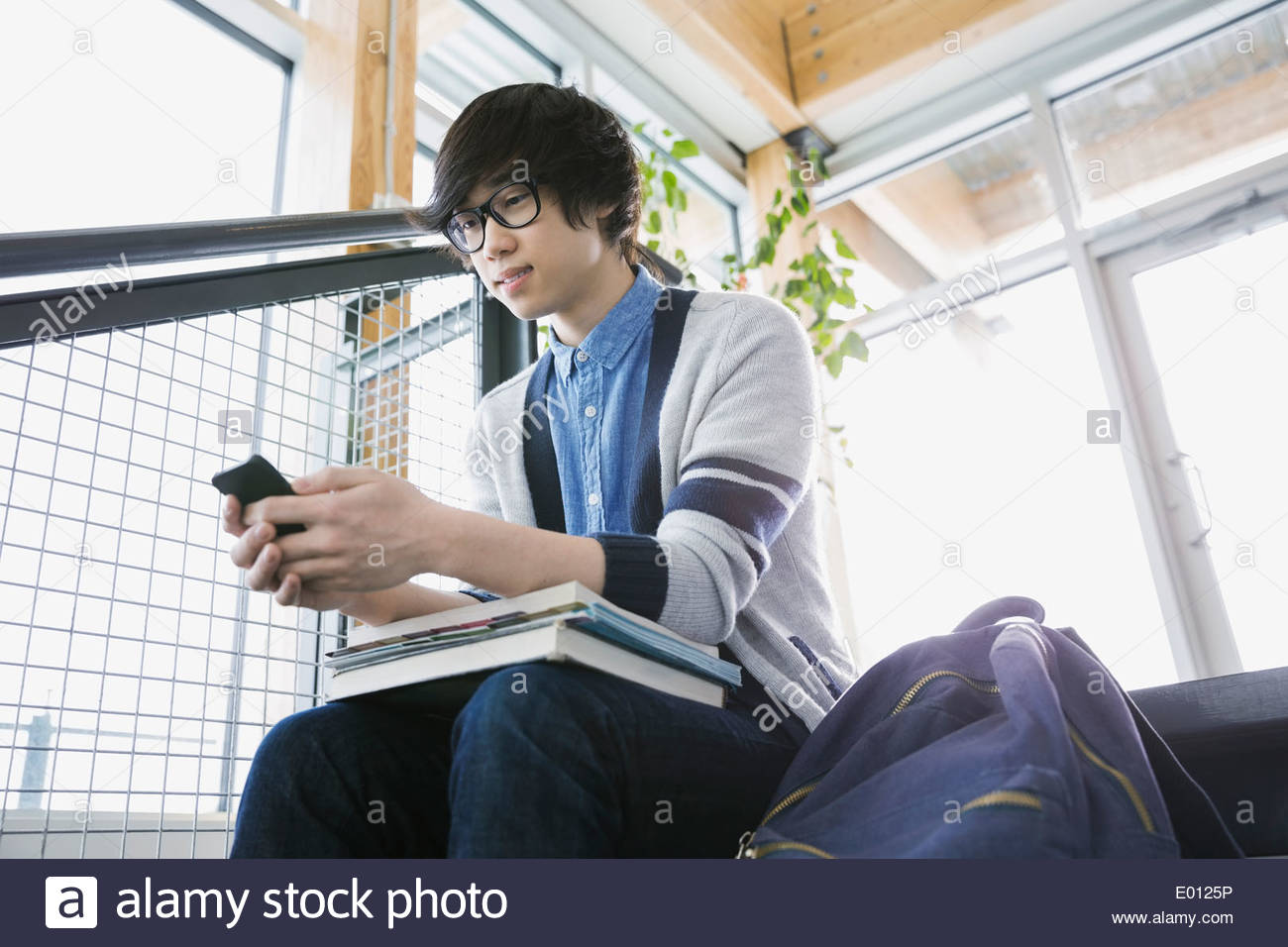 High school boy text messaging with cell phone Stock Photo