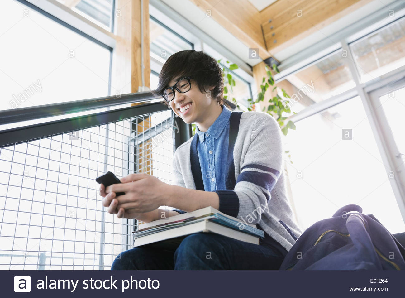 High school boy text messaging with cell phone Stock Photo