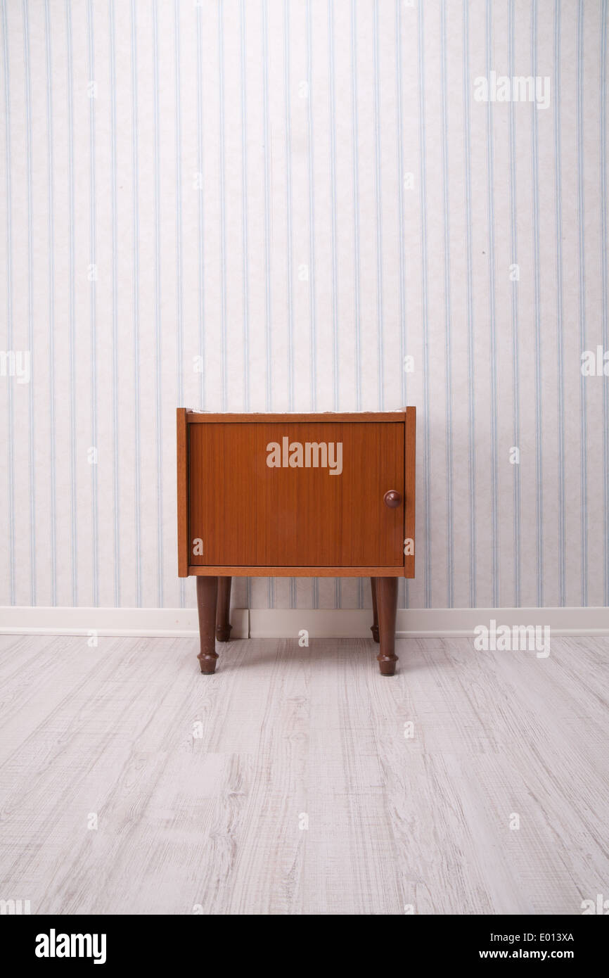 piece of furniture with old fashioned striped wallpaper Stock Photo