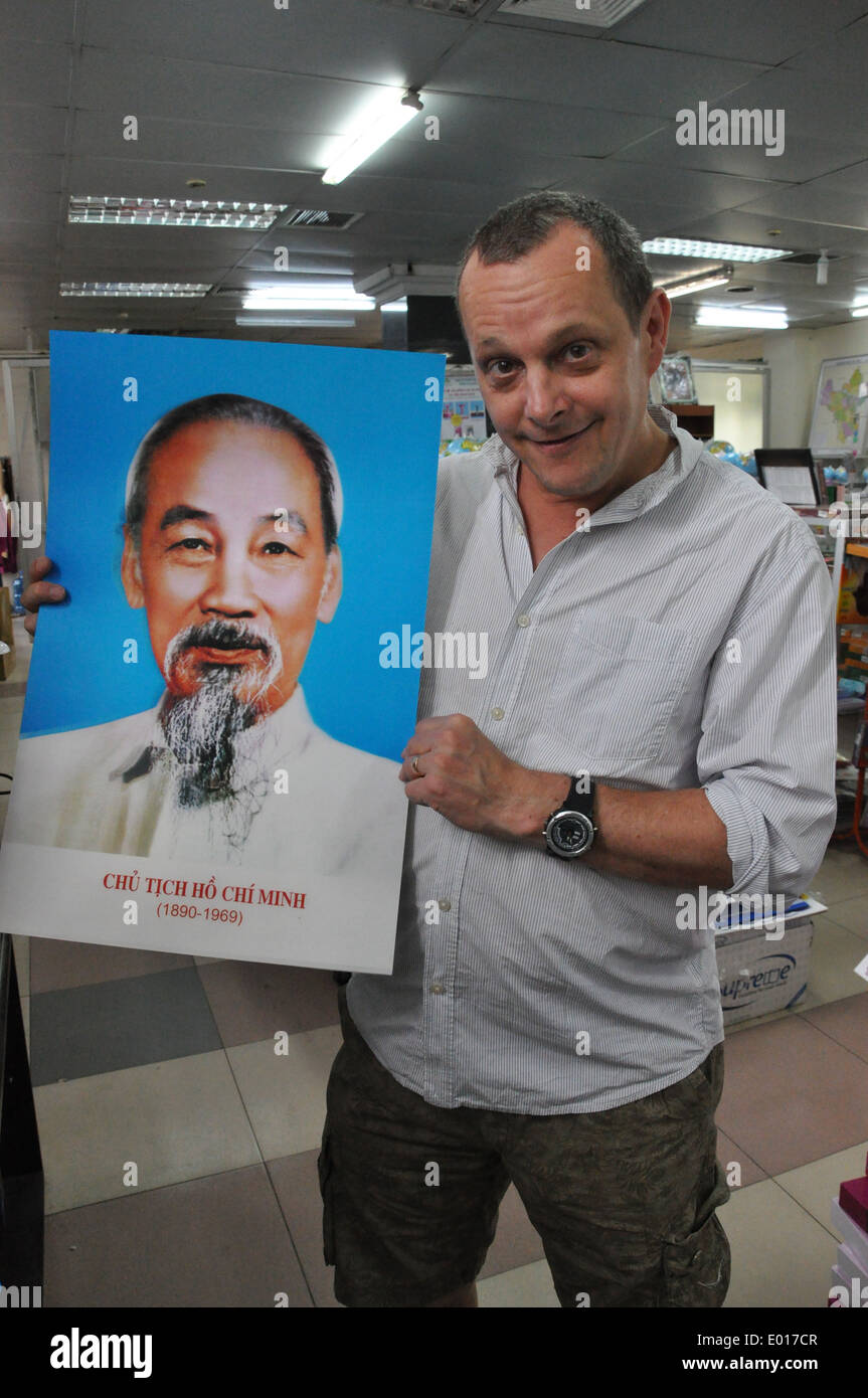 Western visitor holds 3D poster of Vietnamese revolutionary hero and president Ho Chi Minh Stock Photo