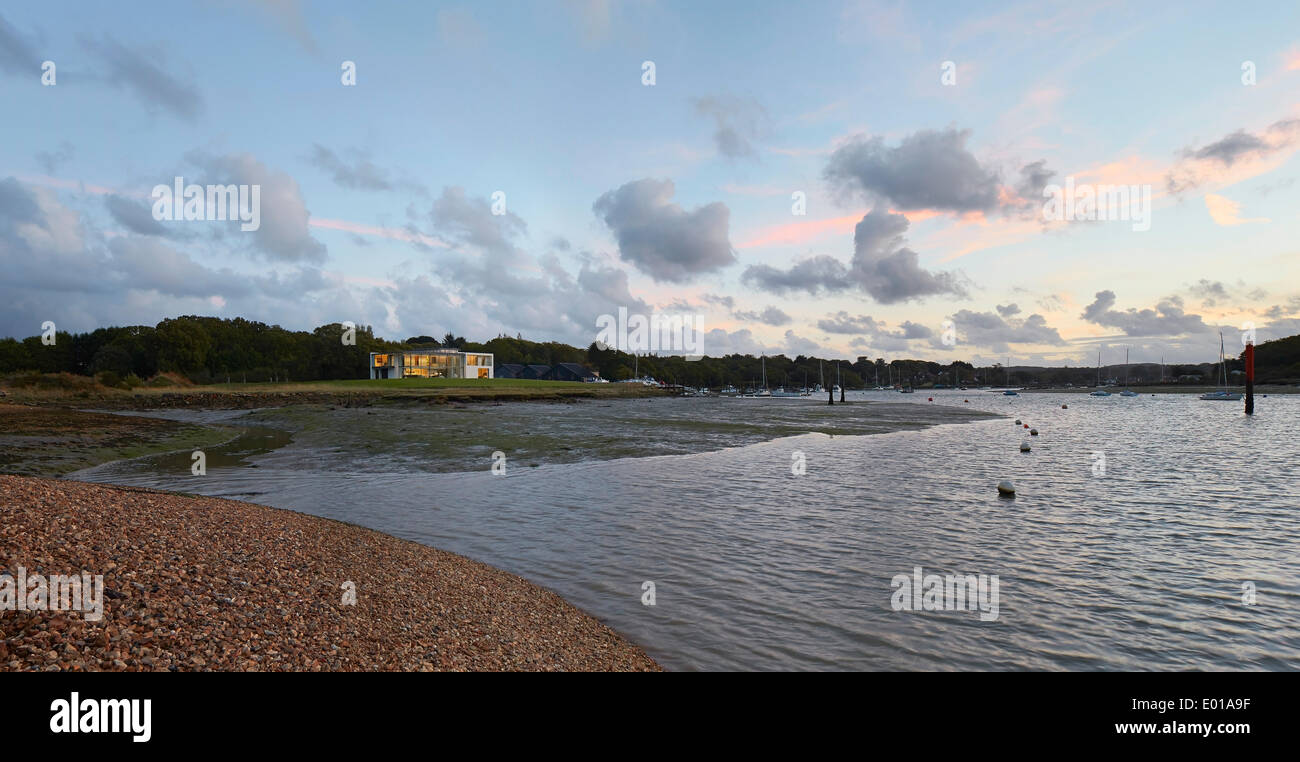 Fishbourne Quay, Wootton Creek, United Kingdom. Architect: The Manser Practice, 2013. Distant elevation of modern home with tida Stock Photo