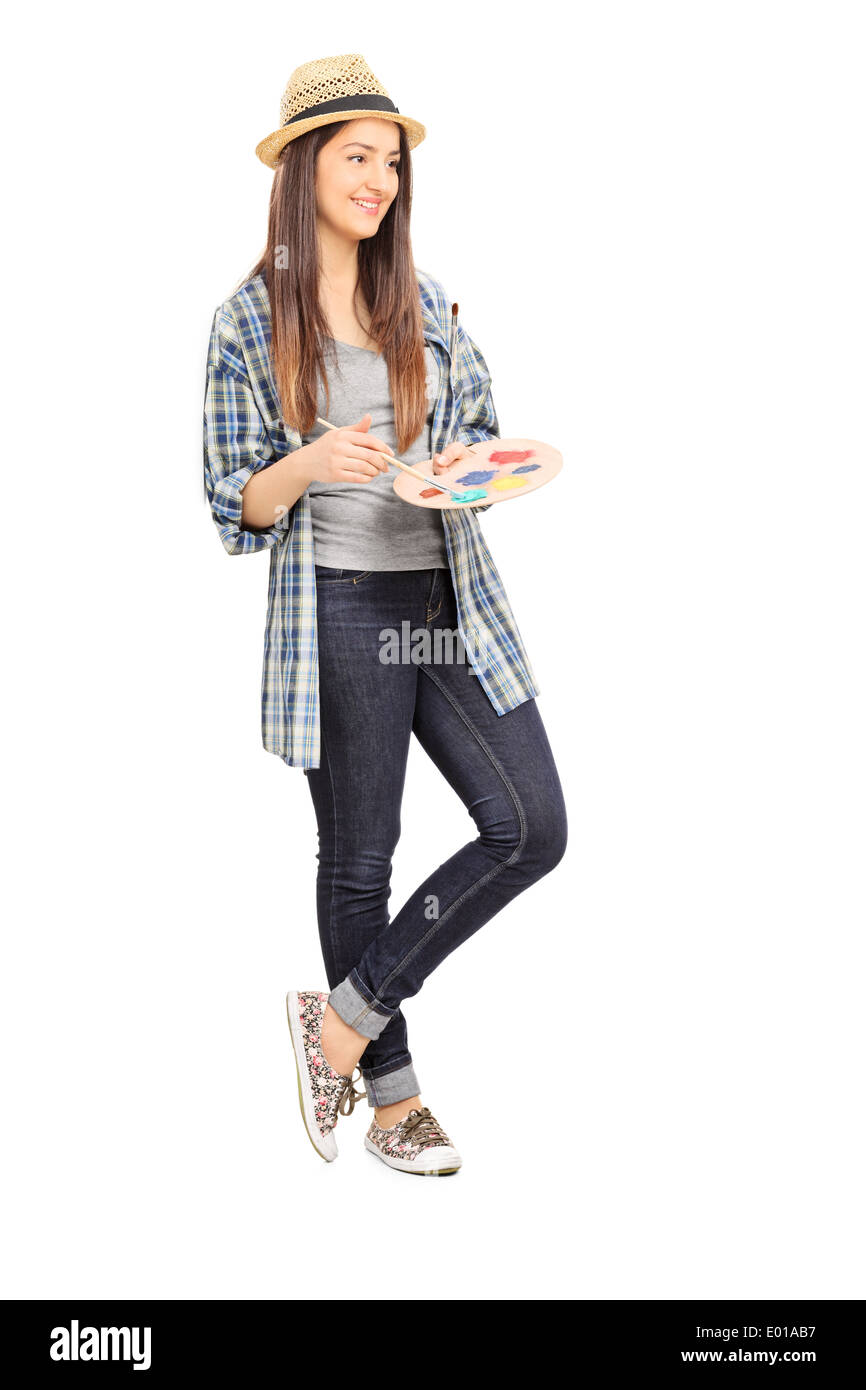 Female artist holding a color palette and leaning on a wall Stock Photo ...