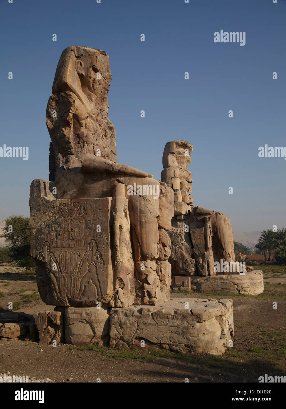 Massive stone statues of Pharaoh Amenhotep III, Colossi of Memnon, Egypt, Luxor, Thebes Stock Photo