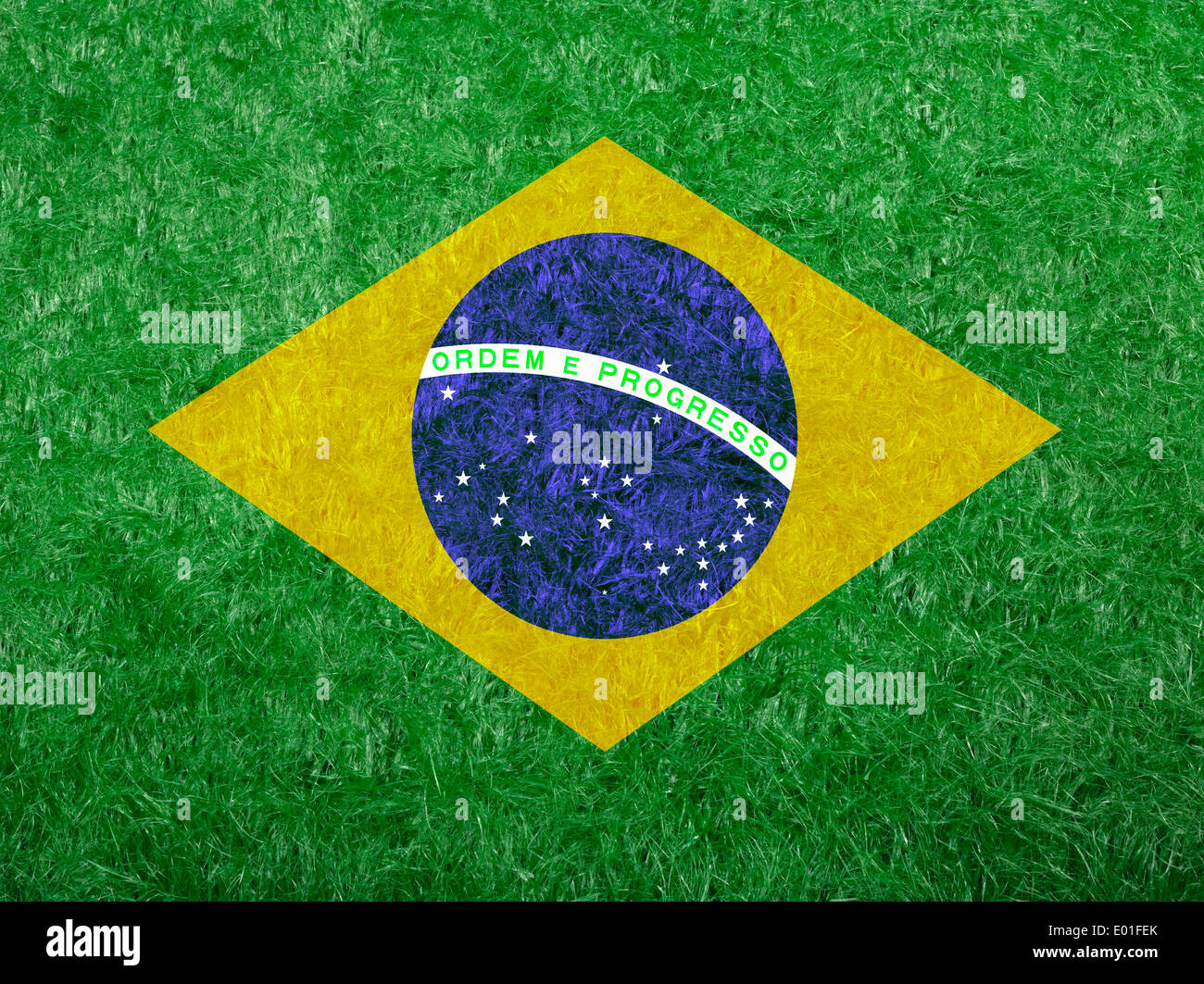 flag of Brazil as a painting on green fake grass Stock Photo