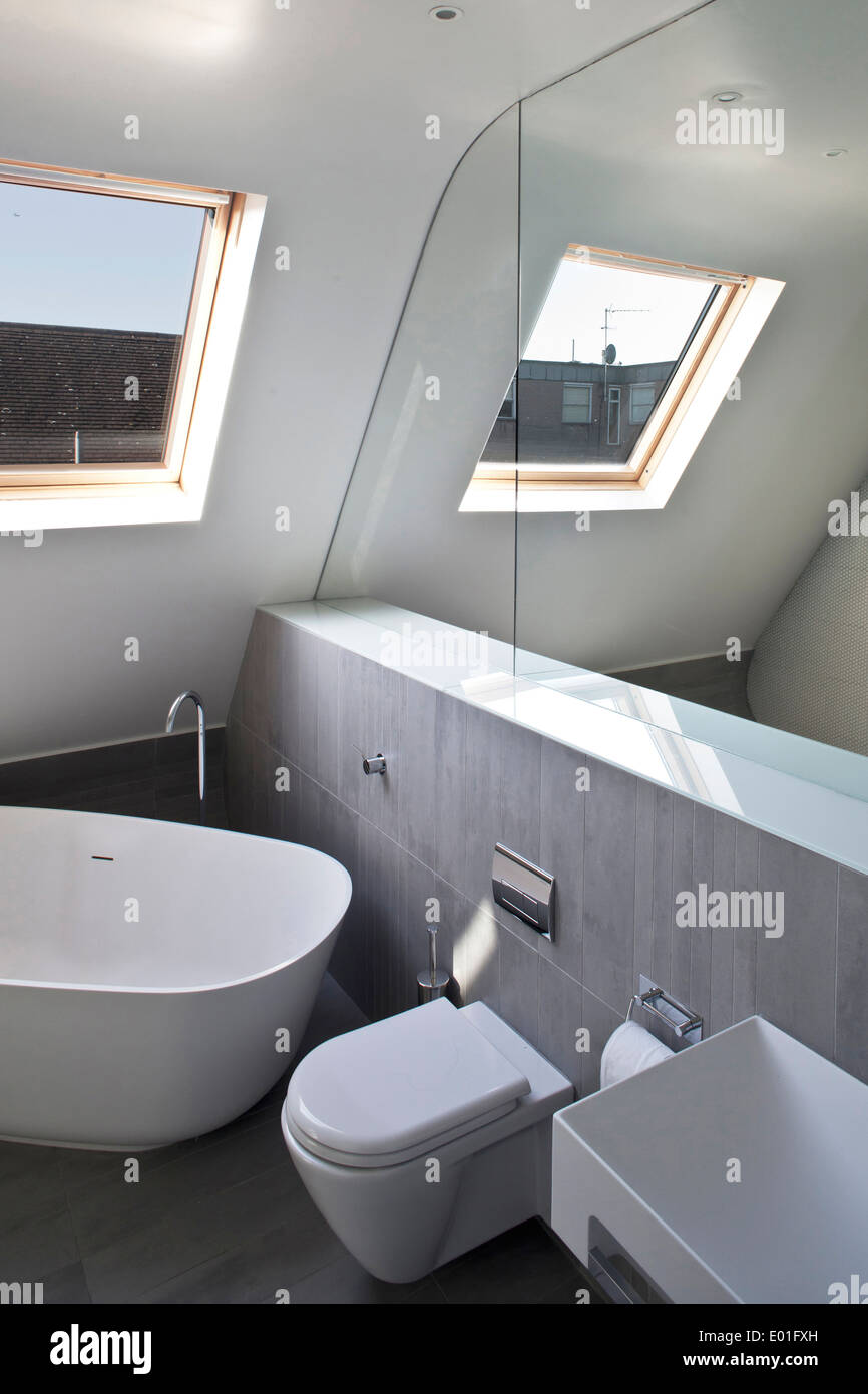 Mirror above bathtub in modern bathroom, Fulham town house, London