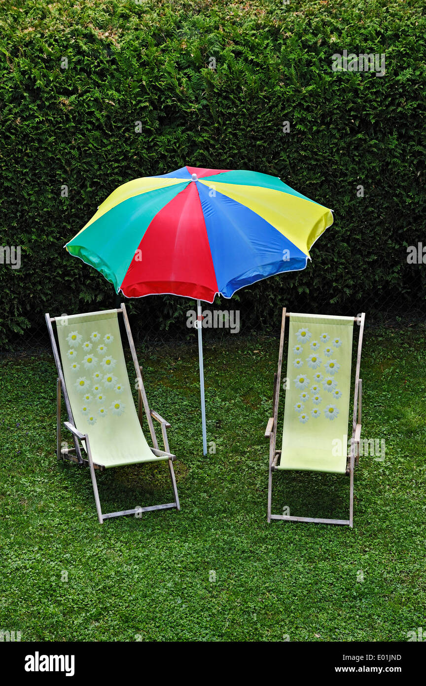 Idyllic garden scene, two beach chairs and a parasol in a garden, Bavaria, Germany Stock Photo