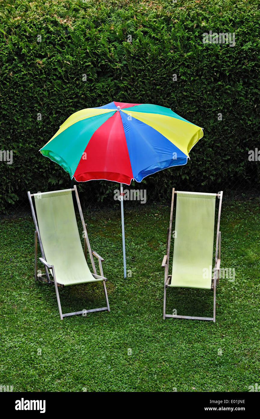 Idyllic garden scene, two beach chairs and a parasol in a garden, Bavaria, Germany Stock Photo