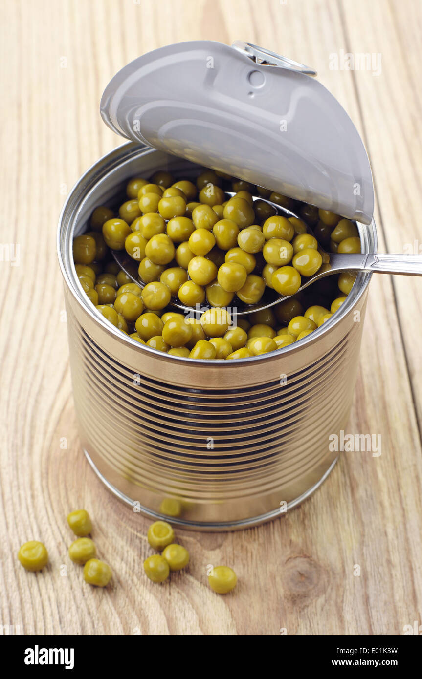 Canned green peas in open tin can on wooden background Stock Photo Alamy