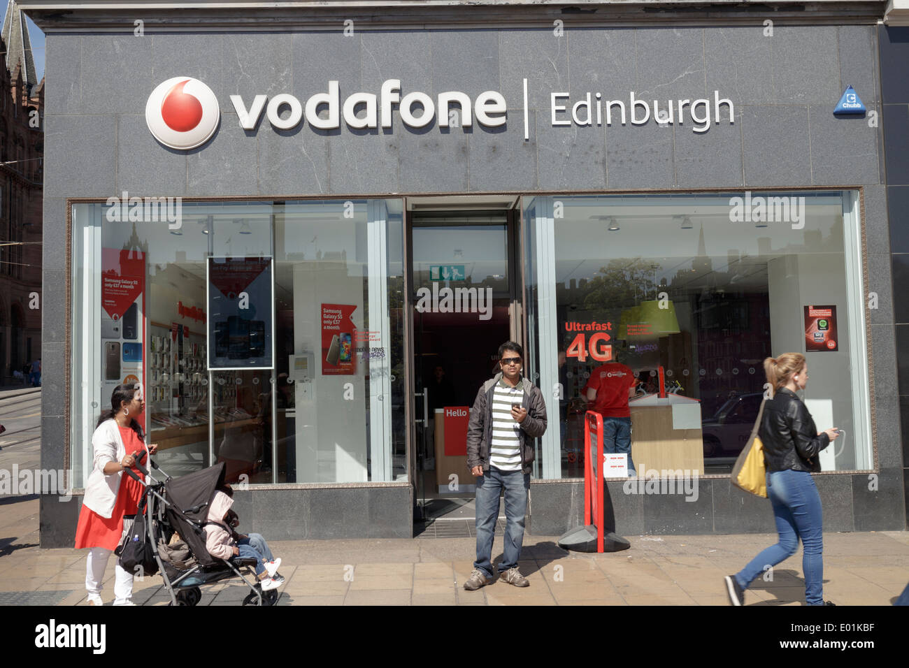 Shoppers outside of the Vodafone mobile phone retailer on Princes Street Edinburgh Stock Photo