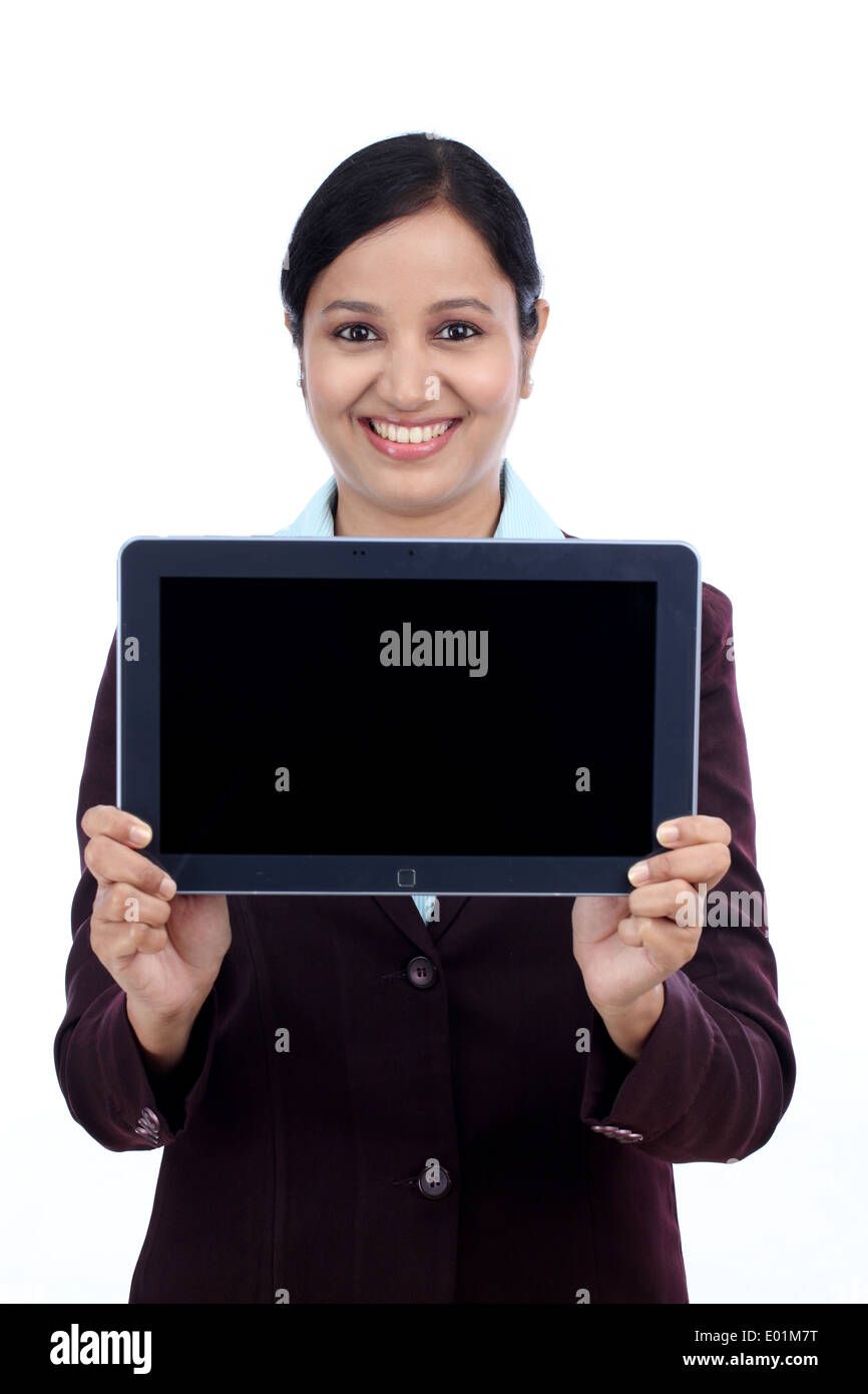 Happy young business woman showing tablet computer screen against white Stock Photo