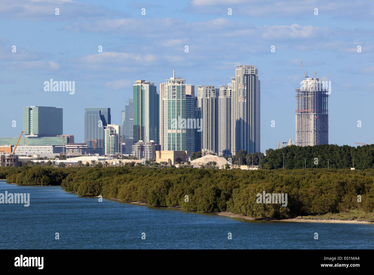 Skyline of Abu Dhabi Al Reem Island with mangrove forest in foreground Stock Photo