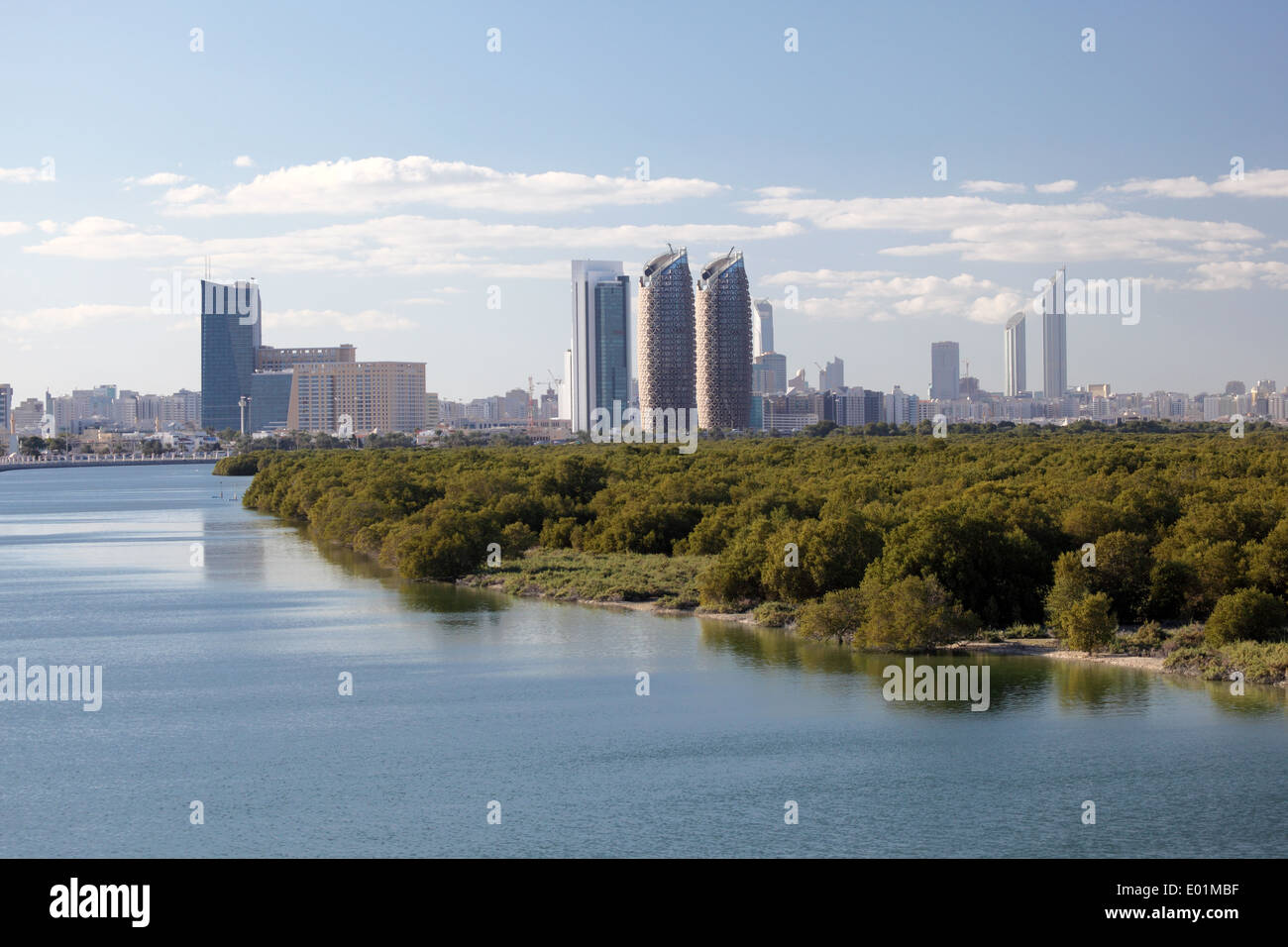 Skyline of Abu Dhabi Al Reem Island with mangrove forest in foreground Stock Photo