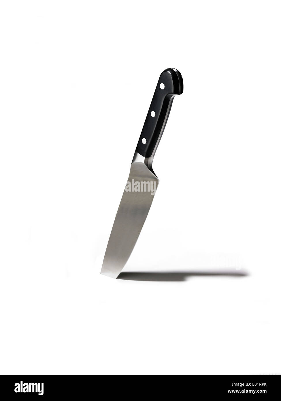 Kitchen knife stuck in white background with shadow Stock Photo