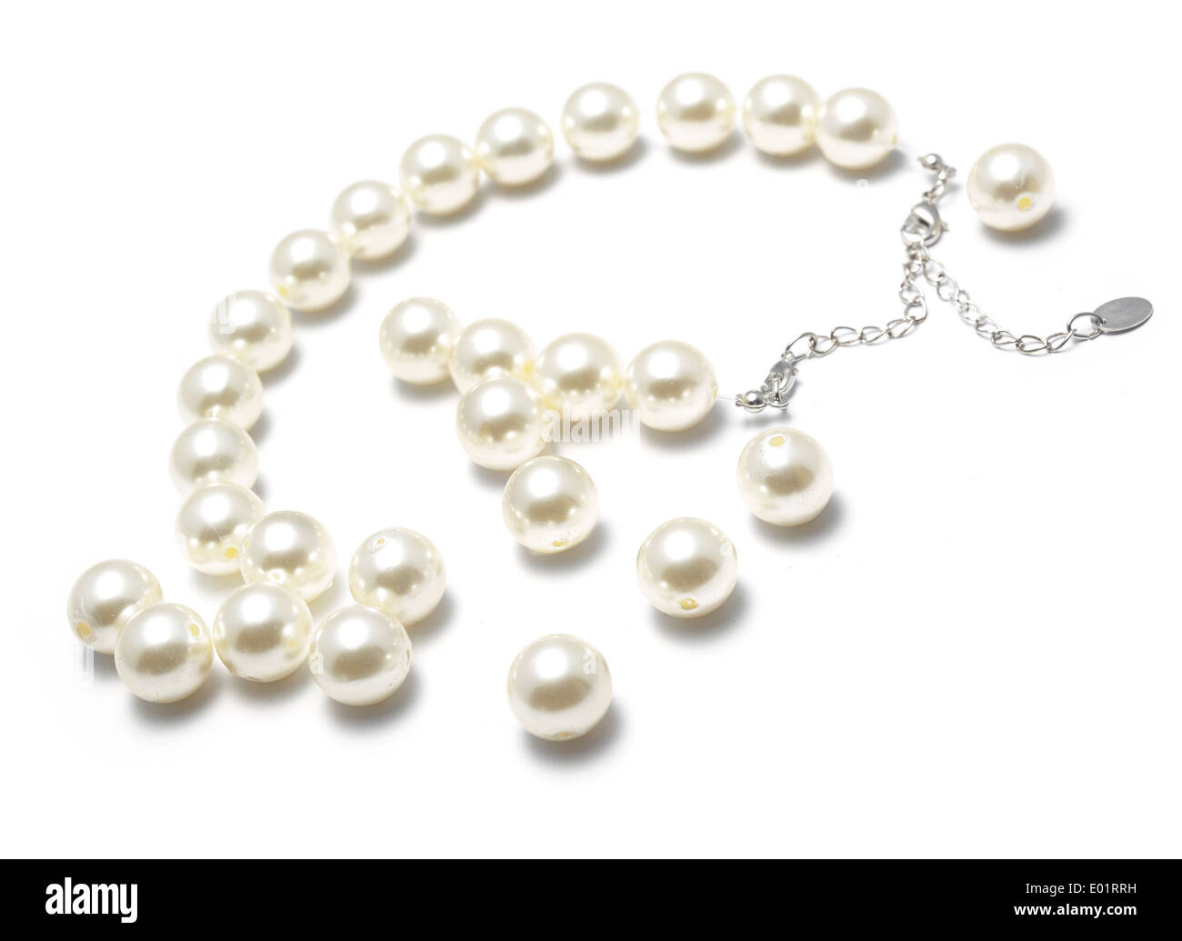 Broken string of pearls, cut out on a white background Stock Photo