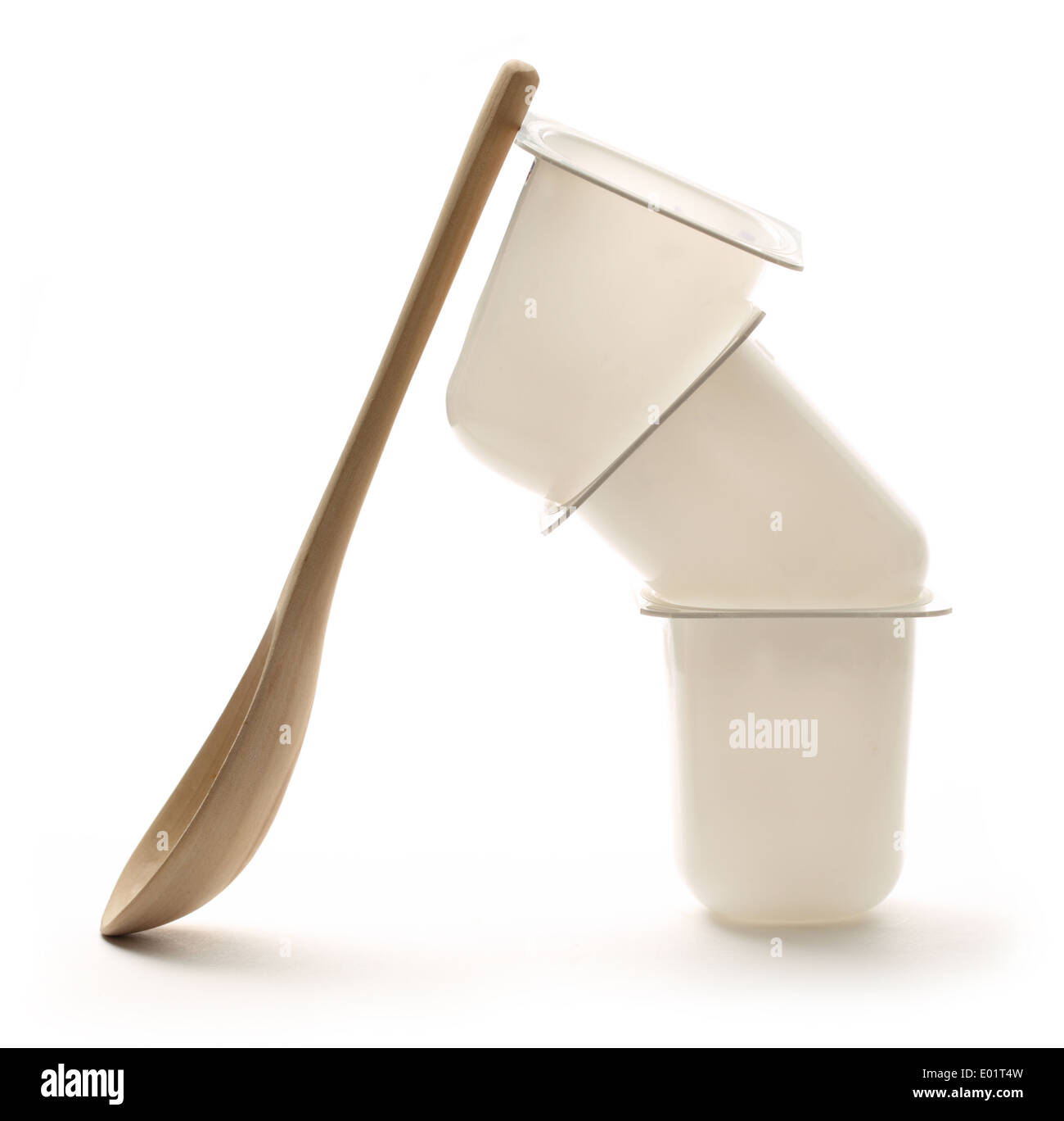 Empty plastic yogurt pots with wooden spoon Stock Photo