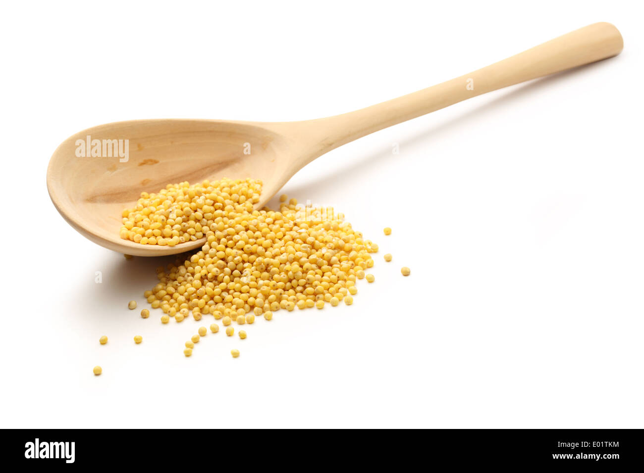 Millet groats with wooden spoon on white Stock Photo
