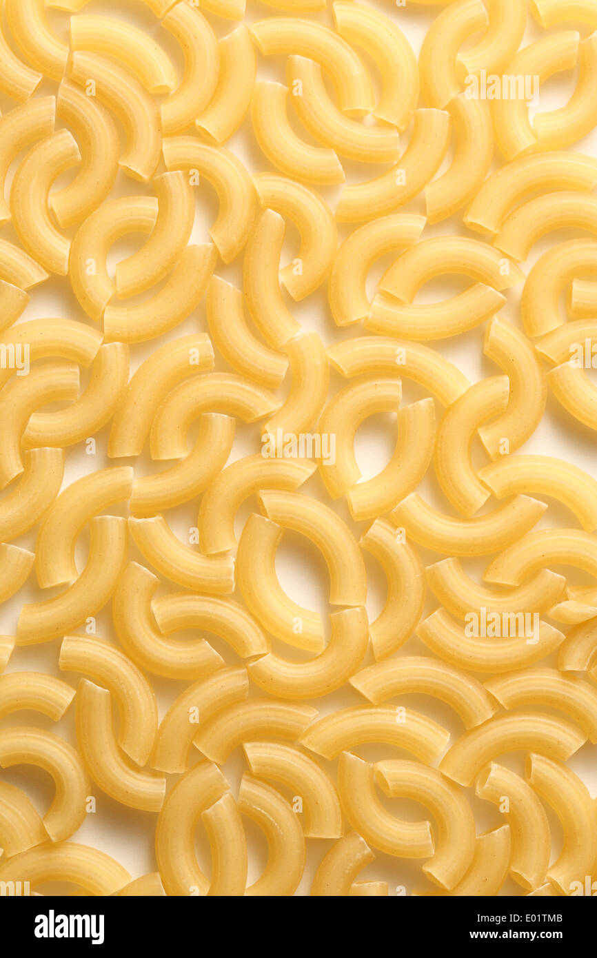 Short ribbed pasta tubes background Stock Photo