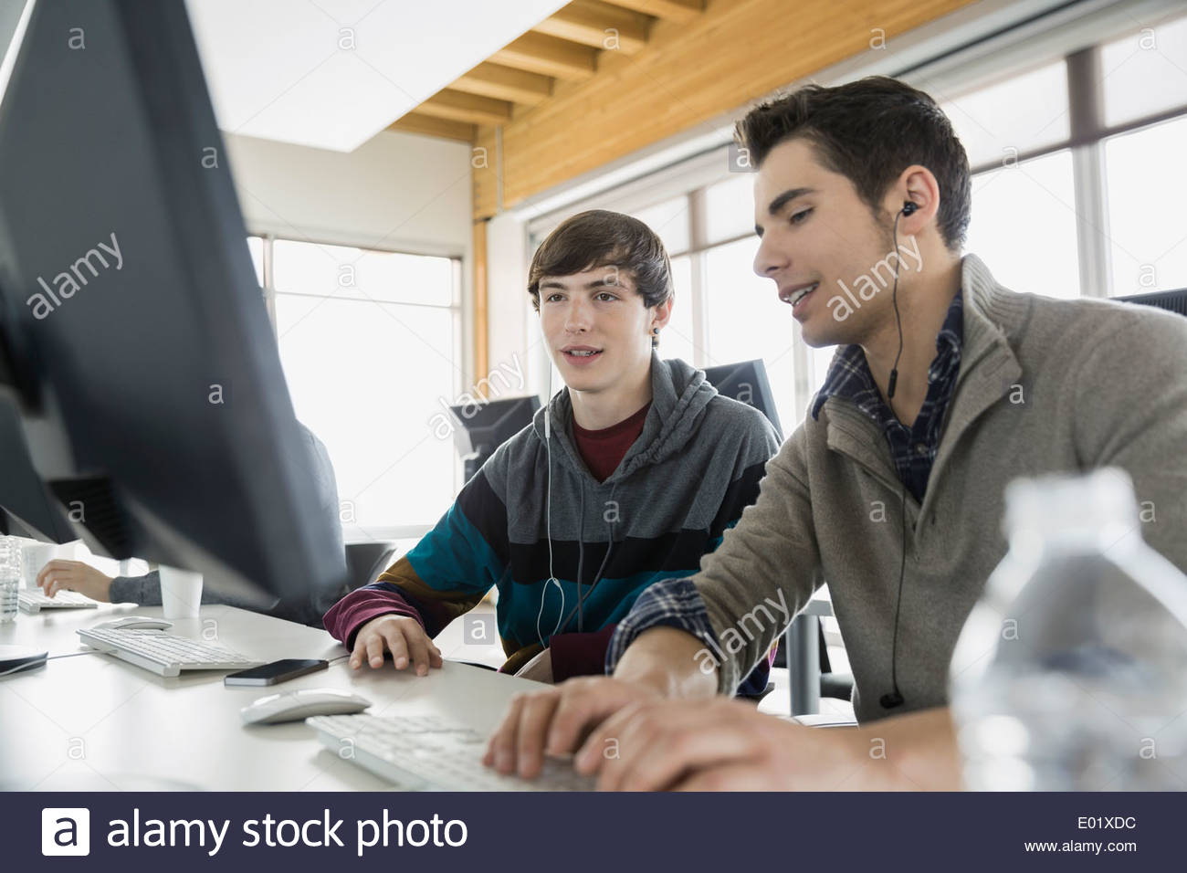 High school students with headphones in computer lab Stock Photo Alamy