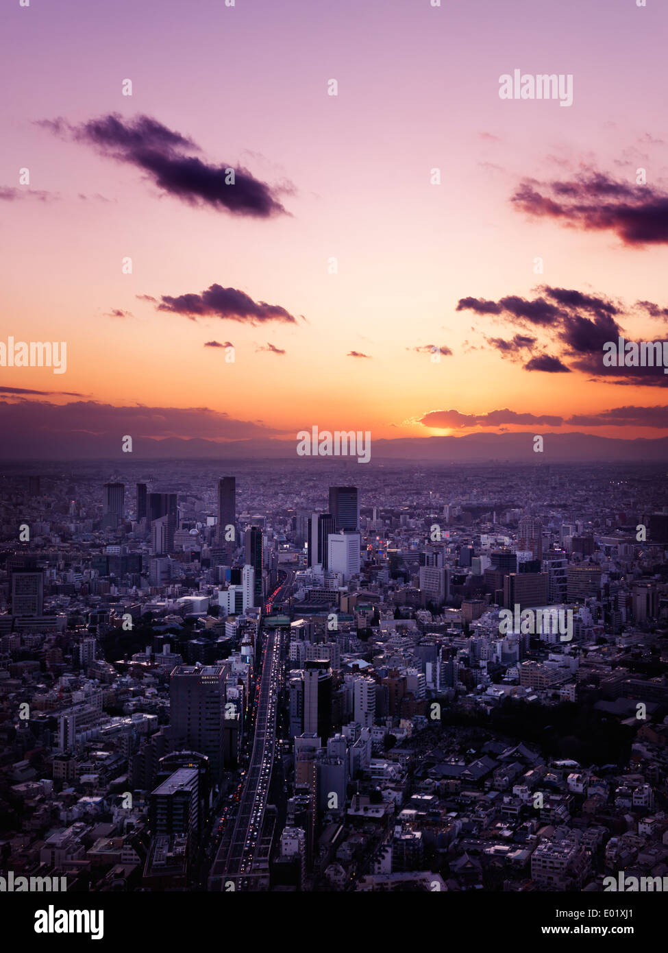 License available at MaximImages.com - Beautiful dramatic sunset scenery of Tokyo city landscape lit with red sunlight, aerial view. Shibuya, Tokyo, J Stock Photo