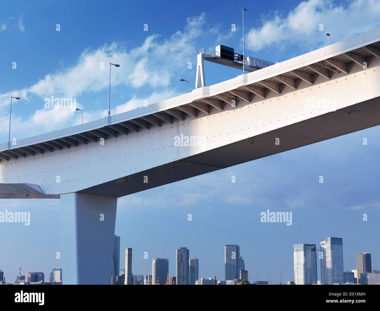 Elevated highway over blue sky with Tokyo city line in the background. Tokyo, Japan. Stock Photo