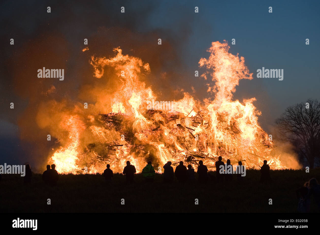 People are watching a huge bonfire, a tradition with easter in North-West Europe. Stock Photo