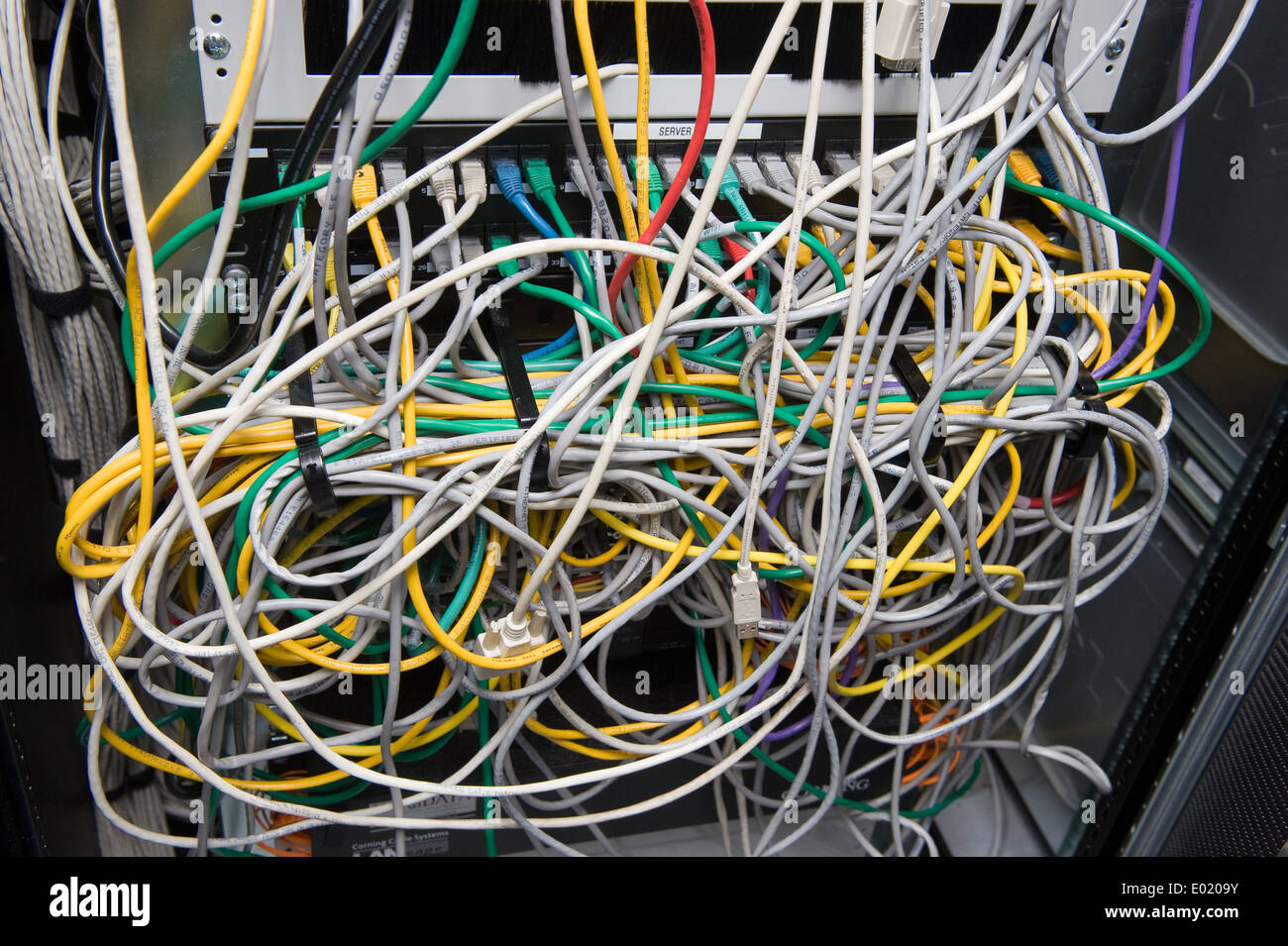 A lot of cables for internet on the back of a big computer Stock Photo