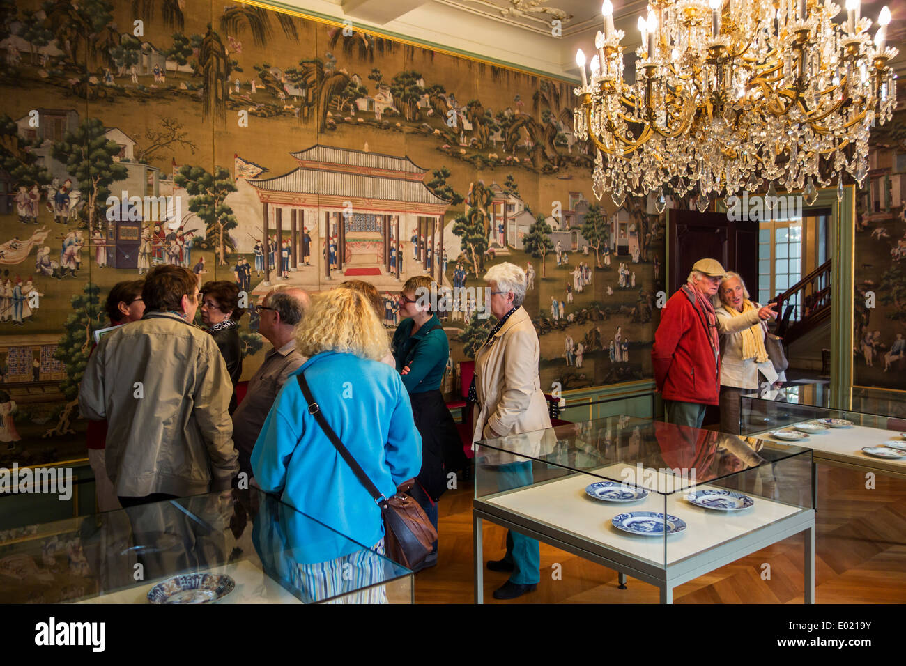 Tourists visiting the 18th century silk wallcovering in the Chinese salon at Museum Arnold Vander Haeghen in Ghent, Belgium Stock Photo