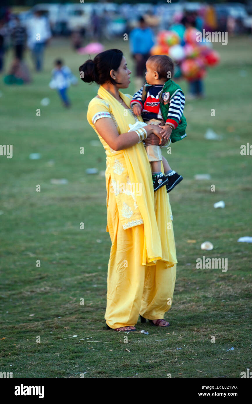 A woman and her baby in the park at India Gate, New Delhi, India Stock Photo