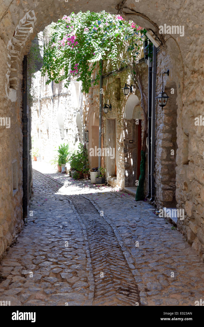 Vaulted arched narrow cobblestone lane lined with stone houses Medieval town Mesta Chios Greece pentagon shape and Stock Photo