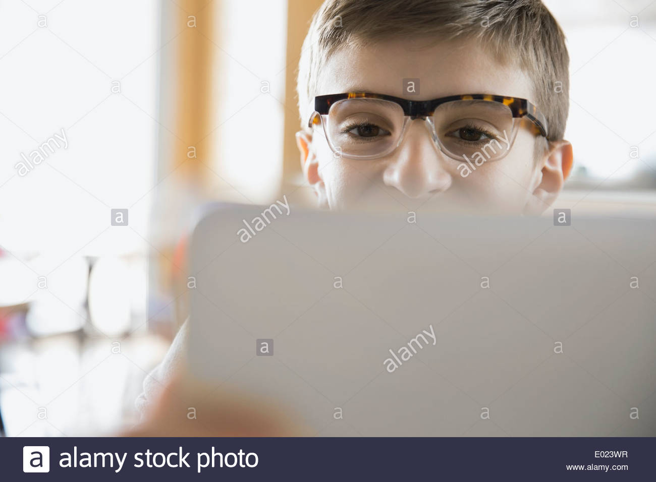 Close up of school boy using laptop in classroom Stock Photo