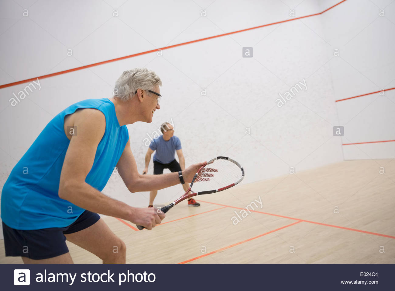 Men playing squash on court Stock Photo