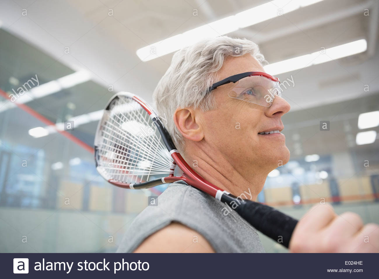 Man in goggles holding squash racket Stock Photo Alamy