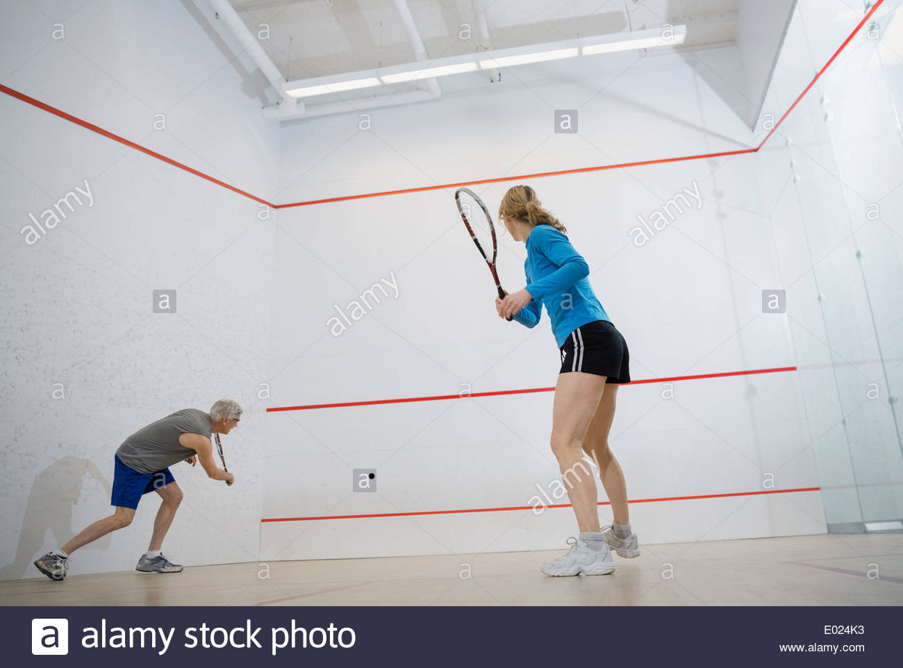 Couple playing squash on court Stock Photo Alamy