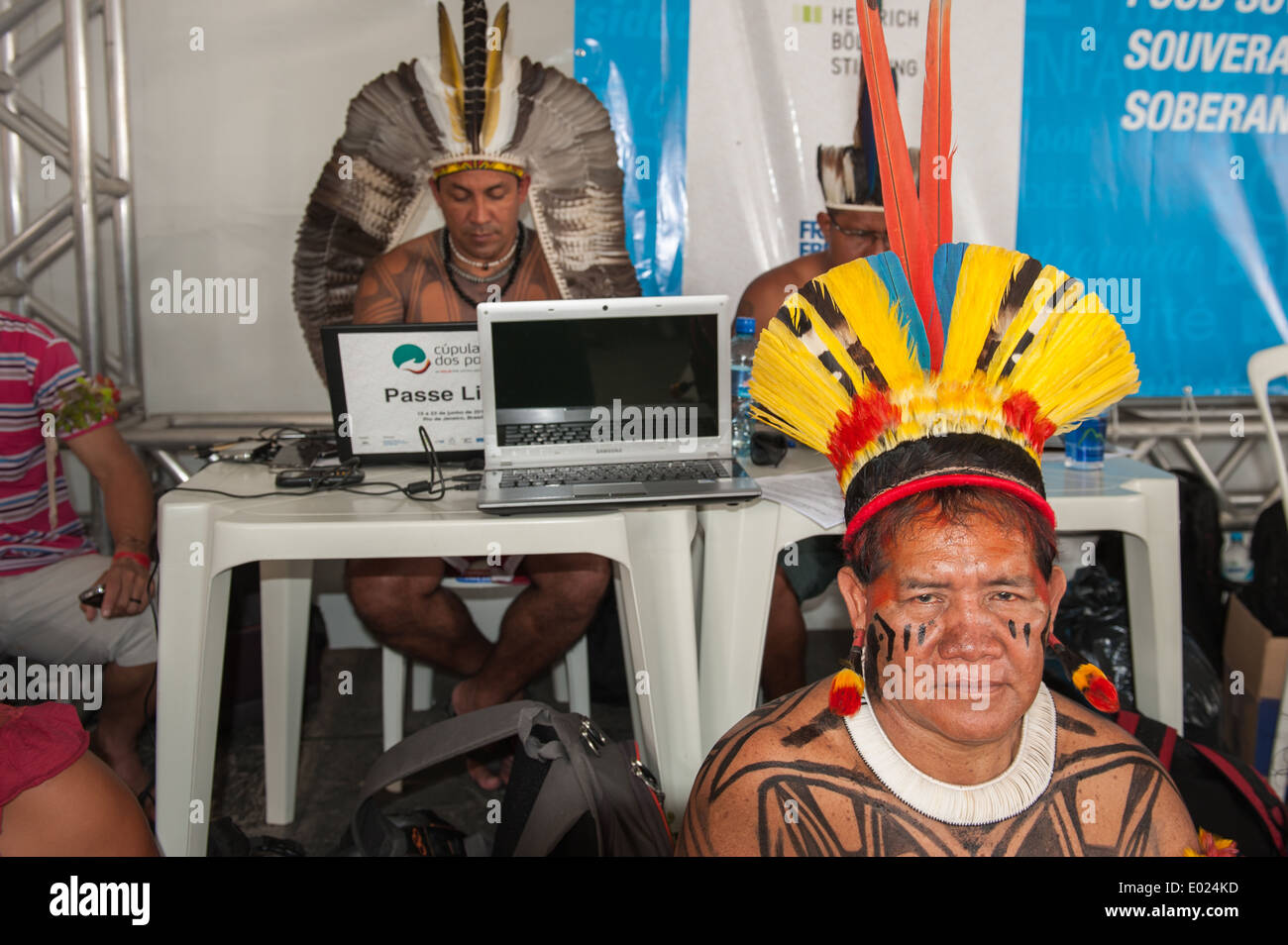 The People's Summit at the United Nations Conference on Sustainable Development (Rio+20), Rio de Janeiro, Brazil, 19th June 2012. Tabata Kuikuro looks on as more and more technology and computers are used by Indigenous Associations around the Amazon. Photo © Sue Cunningham. Stock Photo