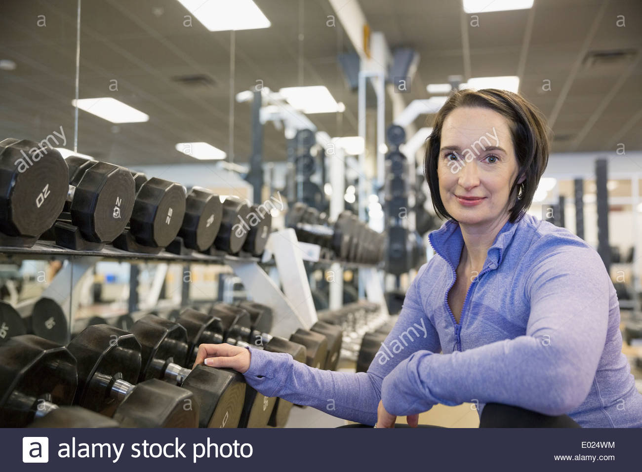 Portrait of woman weight lifting at gym Stock Photo