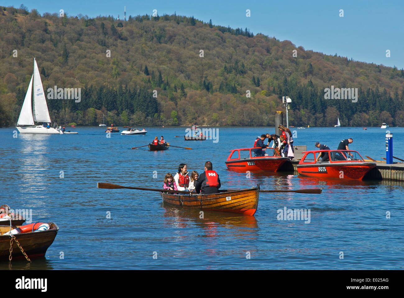 Family in dinghy for hire, Lake Windermere at Bowness Bay, Lake