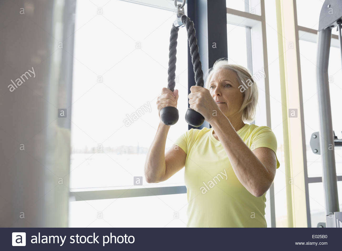Woman using weight machine at gym Stock Photo Alamy