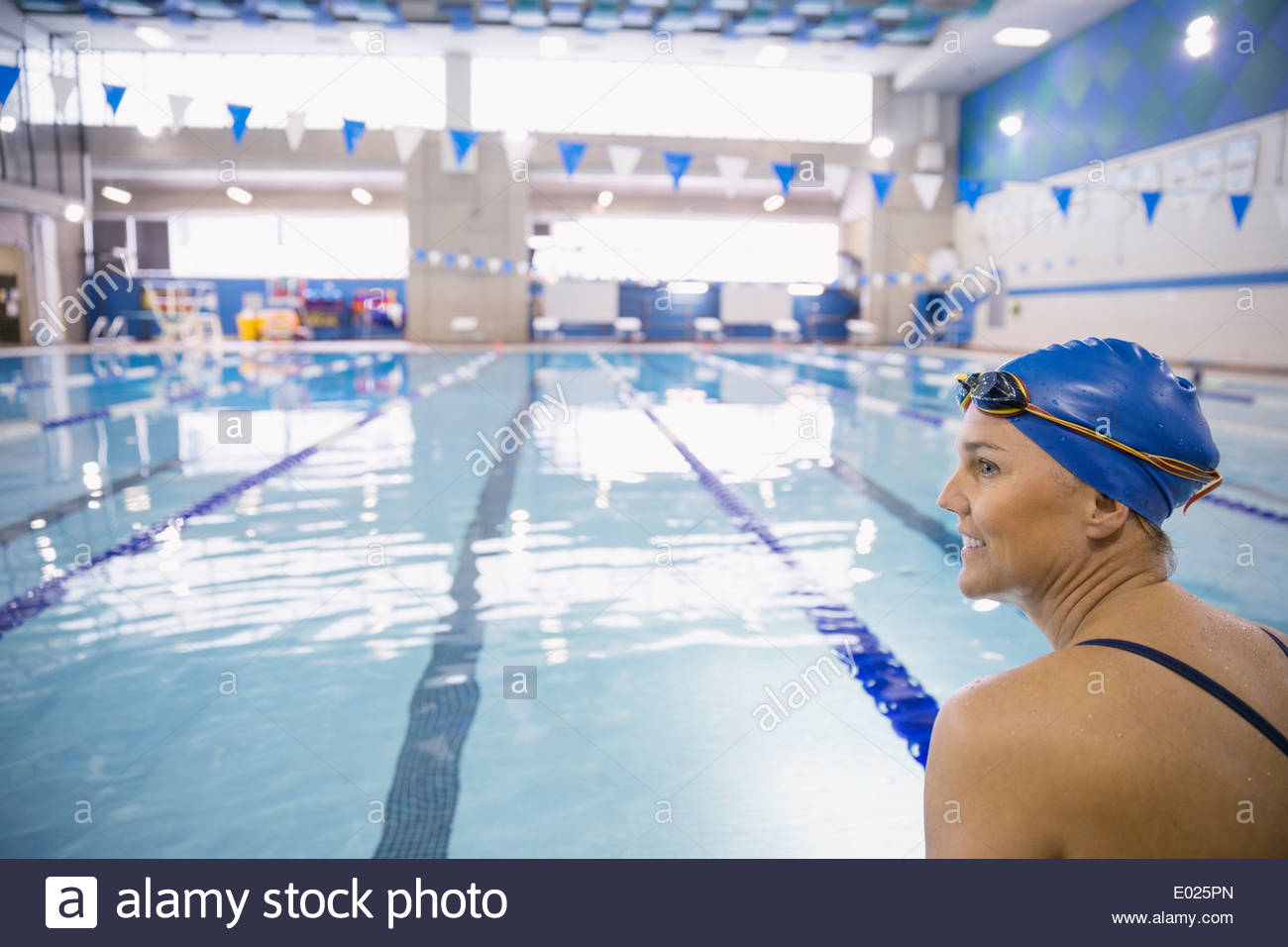 Woman at indoor swimming pool Stock Photo