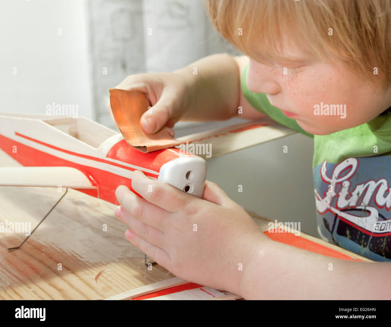 7-year old building wooden model airplane Stock Photo