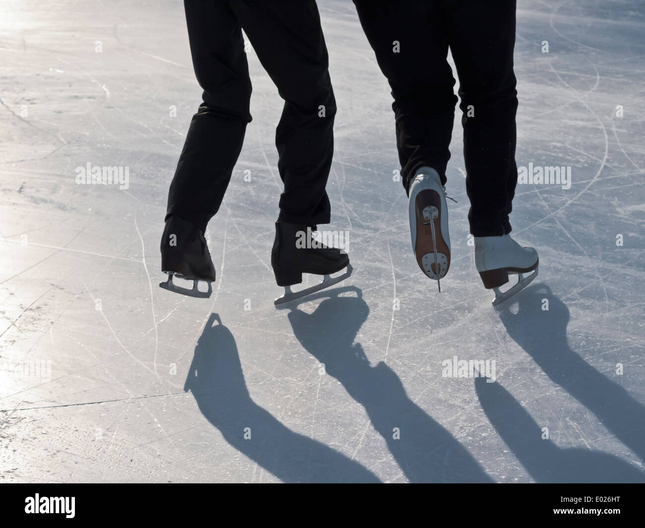 details of figure skaters on ice rink in the bright winter backlight Stock Photo