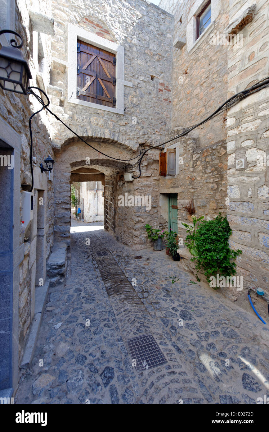 Vaulted arched narrow cobblestone lane with iron gate Medieval town