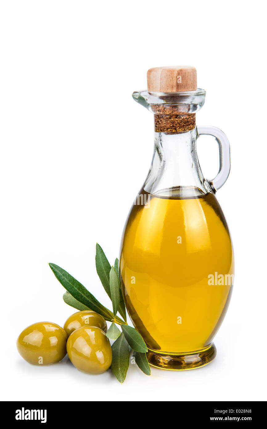 Olive oil in a glass bottle and green olives isolated over a white ...
