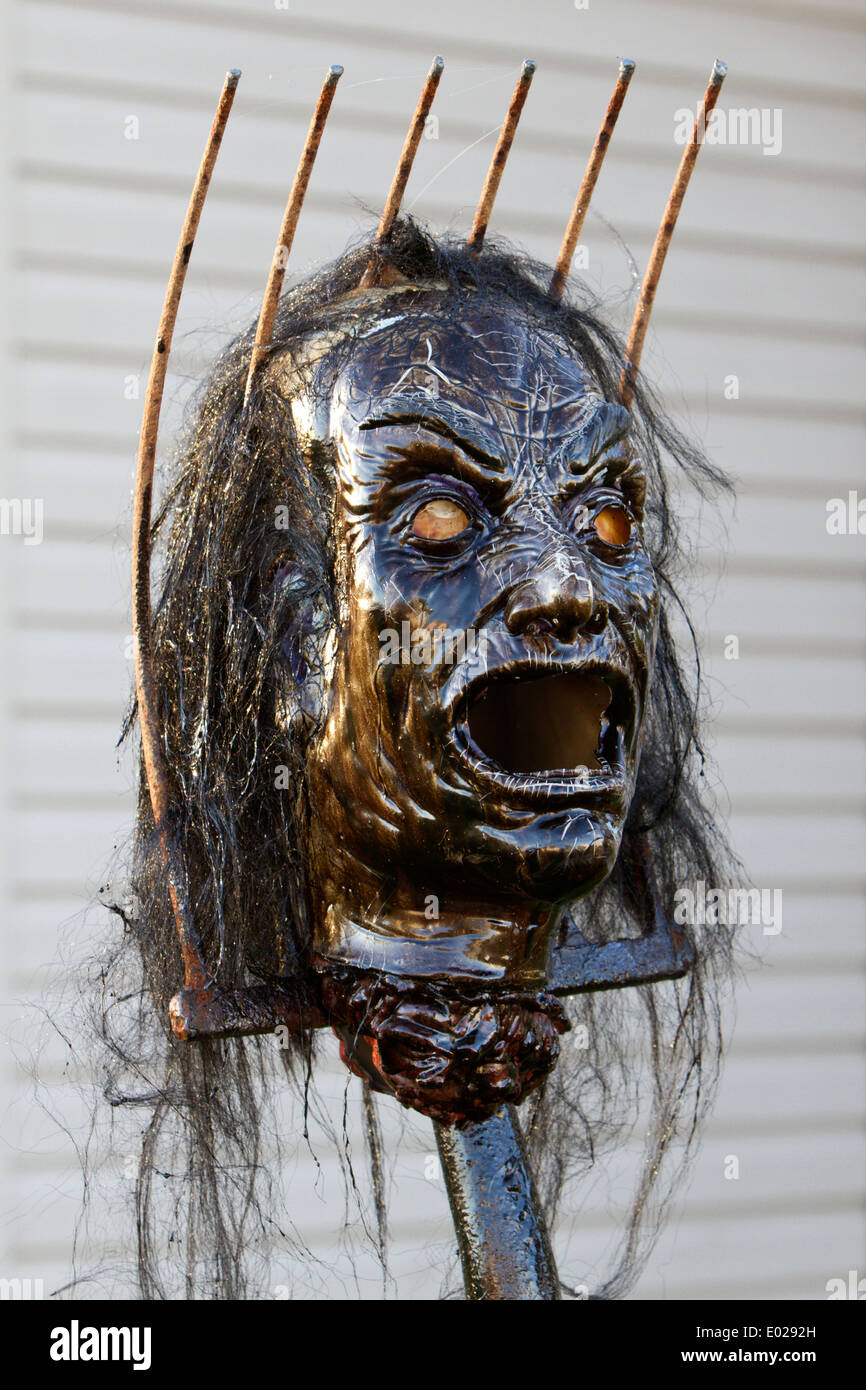 Zombie head impaled on a pitchfork Stock Photo