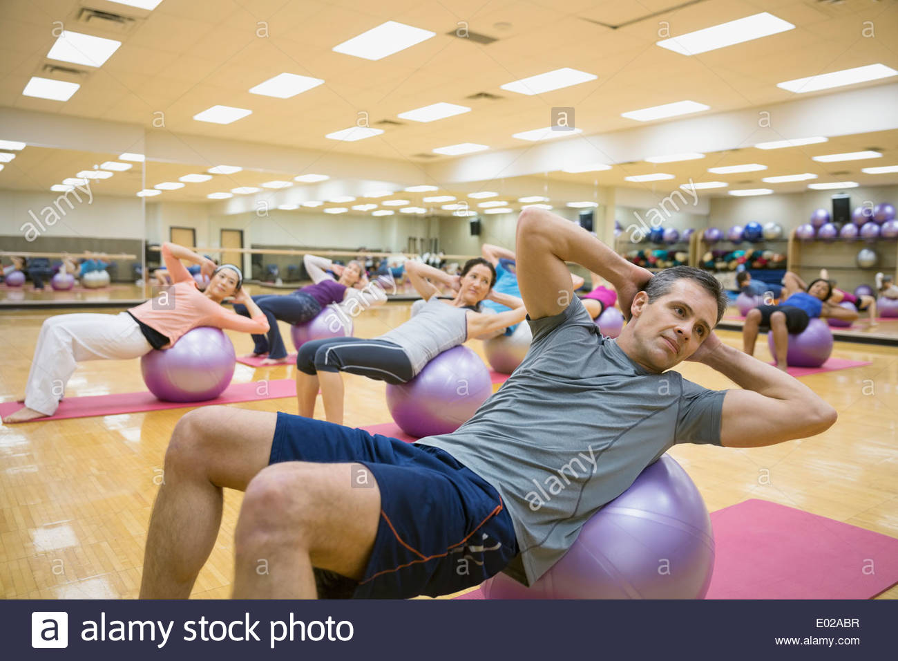 Group on fitness balls in exercise class Stock Photo