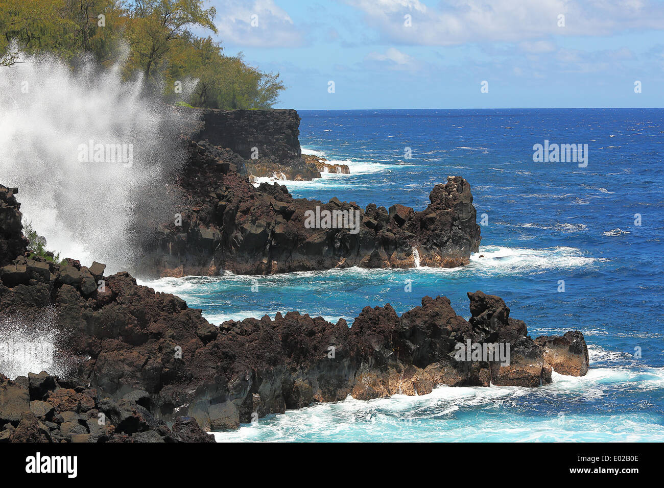 Ocean waves along the lava rock shore of Hawaii Stock Photo
