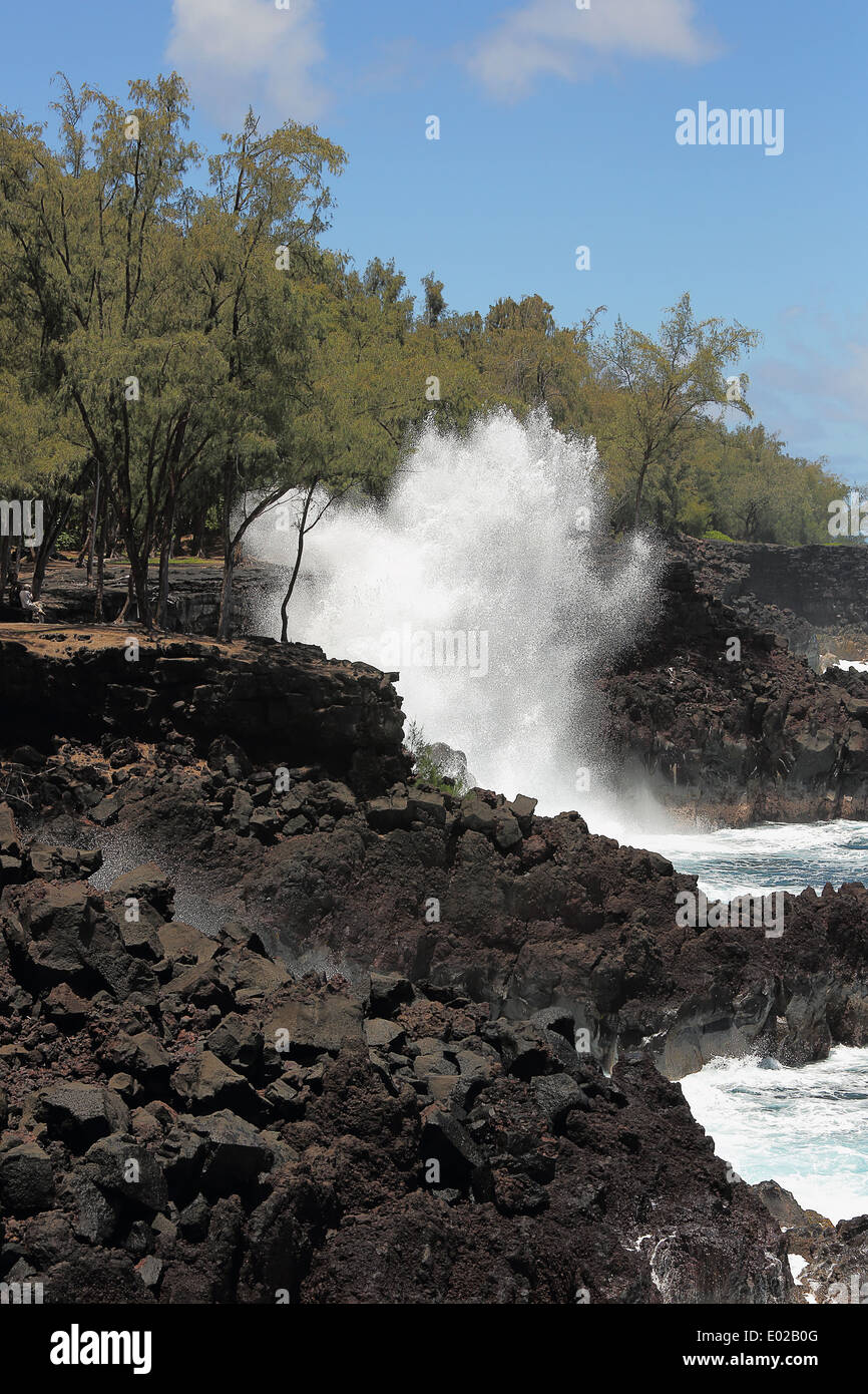 Ocean waves along the lava rock shore of Hawaii Stock Photo