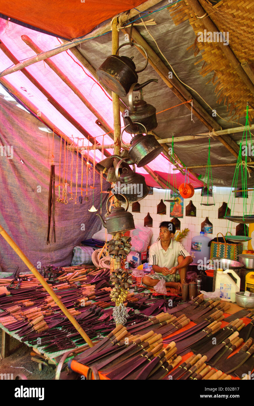 A stall selling knives and metal pots can be found in a Burmese flea market Stock Photo