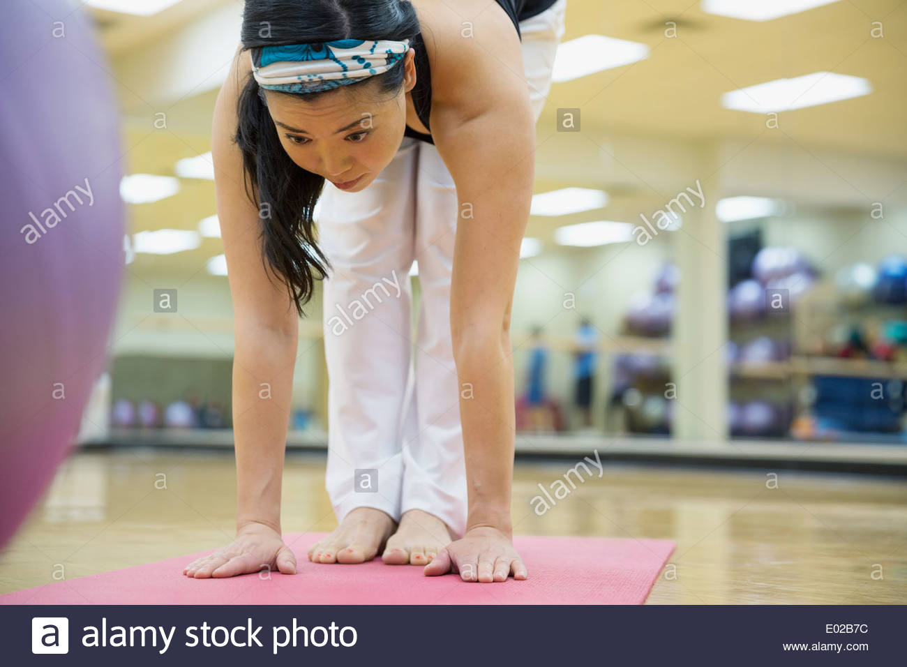 Woman practicing yoga at gym Stock Photo
